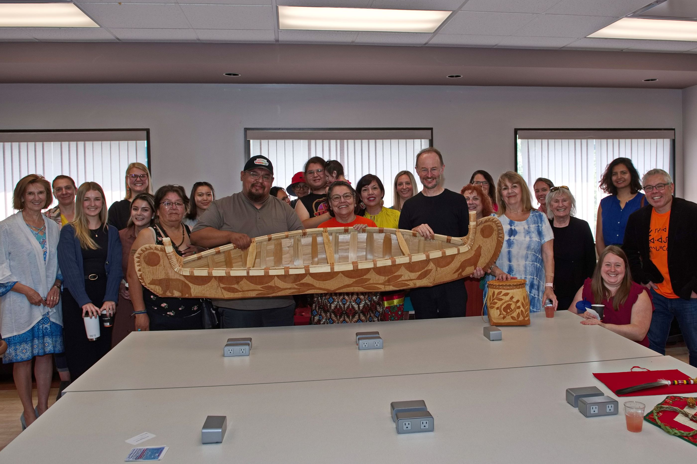 Group of people with indigenous canoe